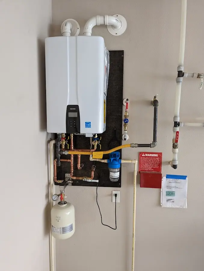 Professional plumber installing copper piping in a Day Valley home